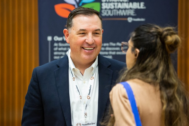 an employer chatting with a student at an event