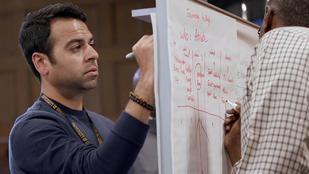 photo of professional mba student working on whiteboard