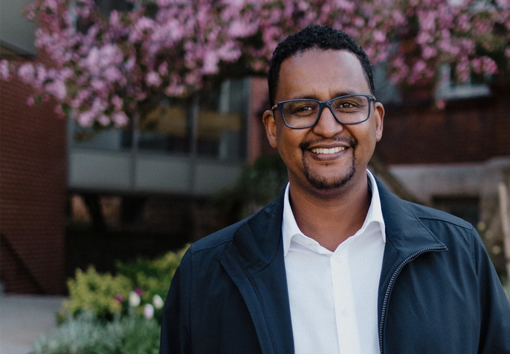 student smiling outside