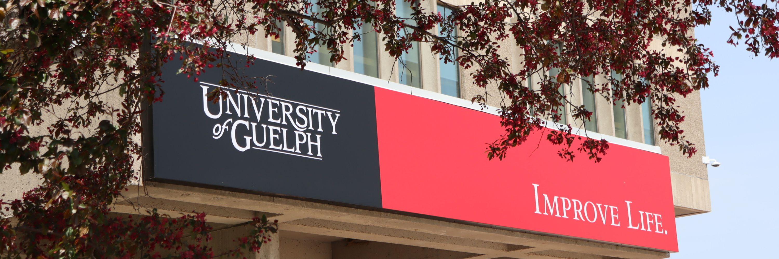 Photograph of the University of Guelph, Improve Life sign outside of the University Centre.