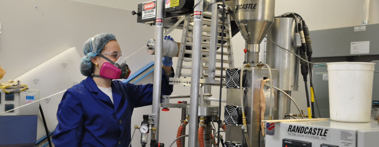 A person in lab equipment works in a lab