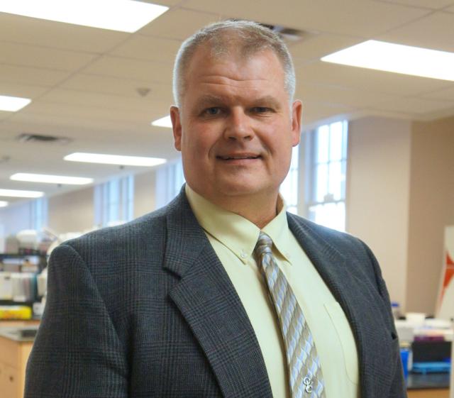 Dr. Jim Petrik standing in a lab