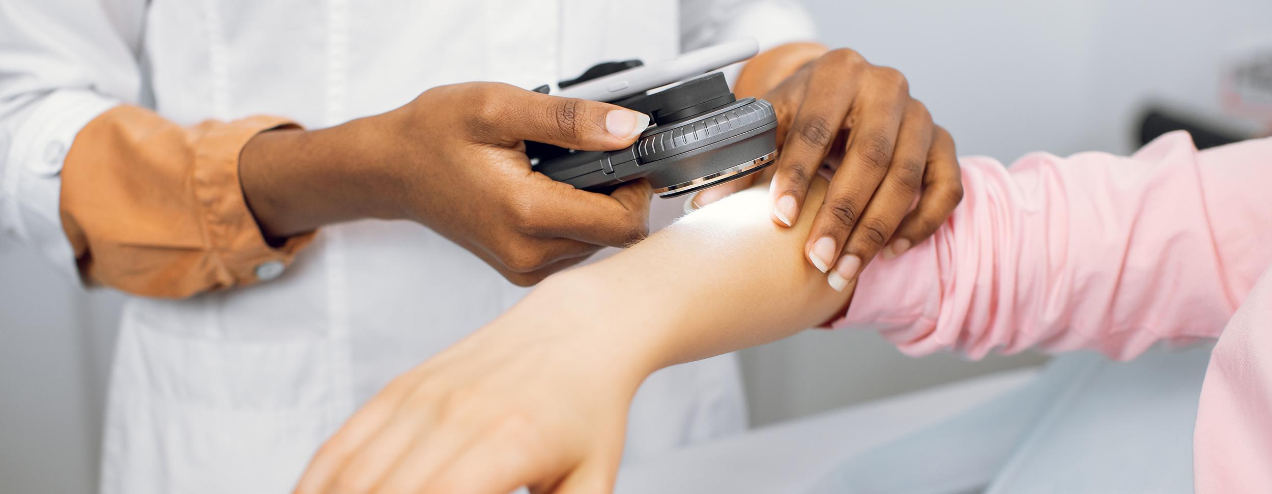  Image of doctor examining patient's arm.