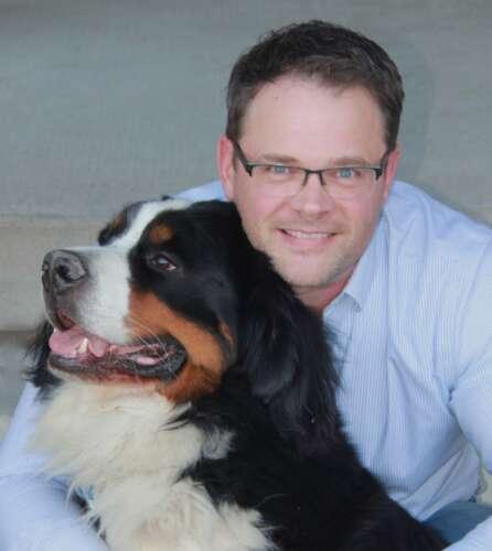 Dr. Jason Coe, pictured with his dog Harley.