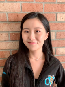 Miranda (Yuan) Bie looking through a microscope