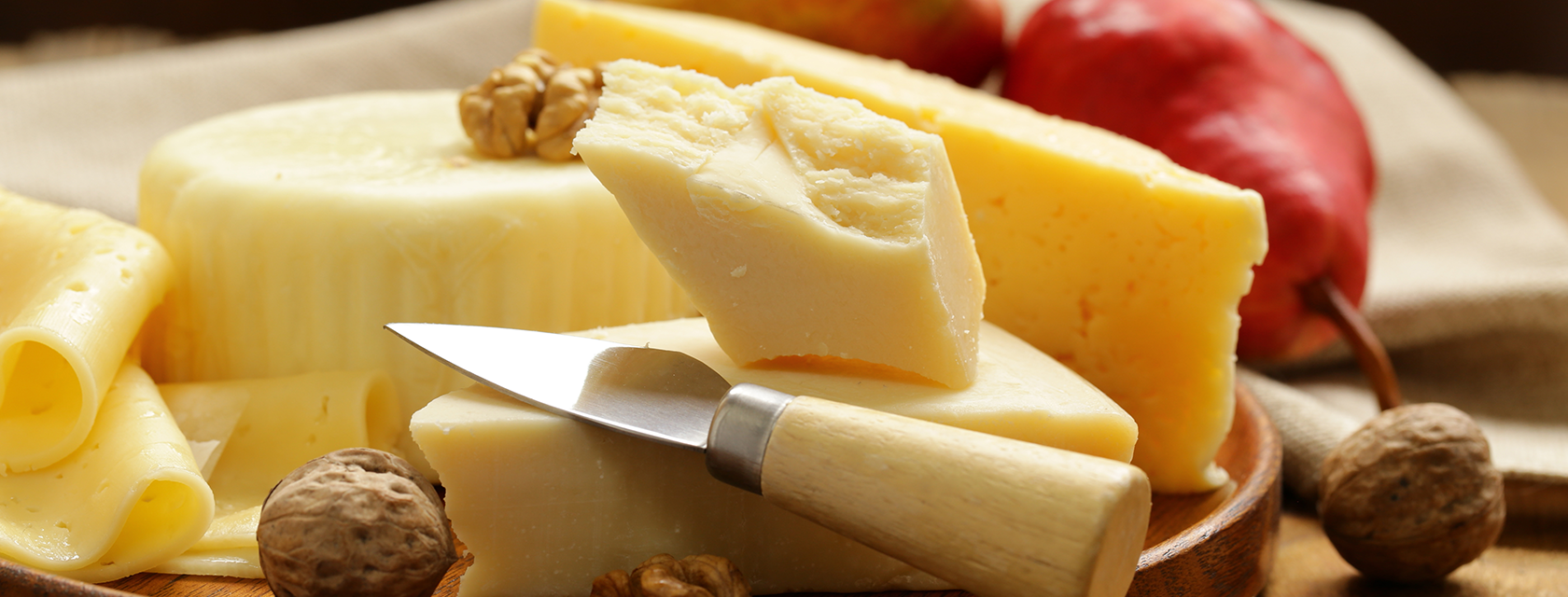 cheese on a board with a knife