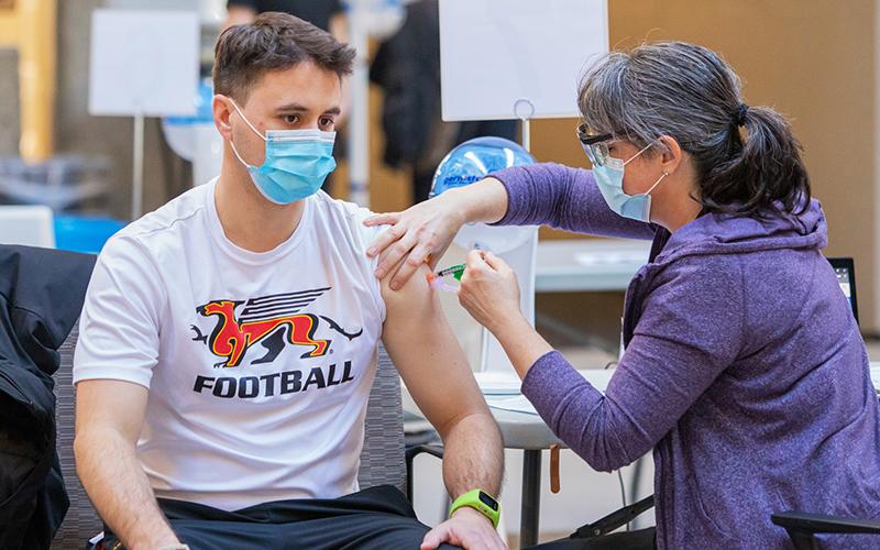 U of G student getting a vaccine on campus