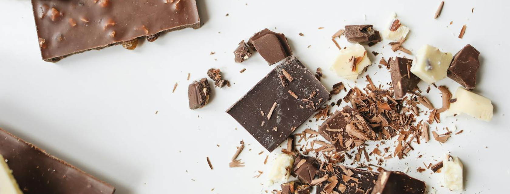 chocolate on a white table top, broken into pieces