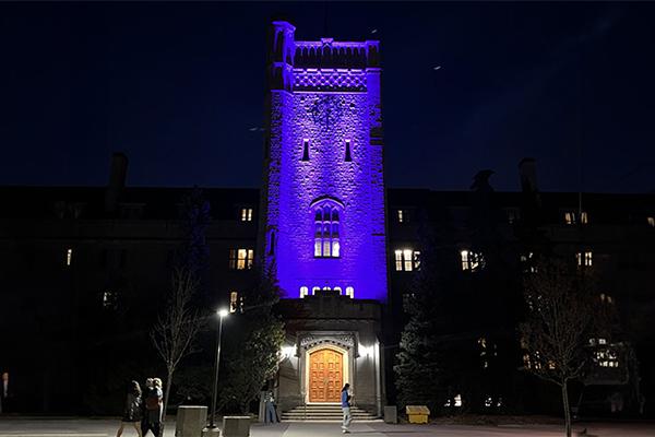 U of G Jonston Hall building at night lite up with purple lights