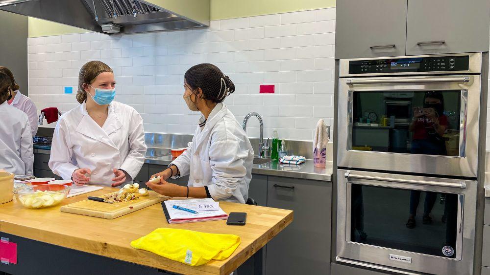 Students preparing a meal in the Anita Stewart Memorial Food Laboratory