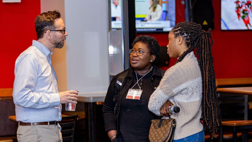 Group of three people having a conversation