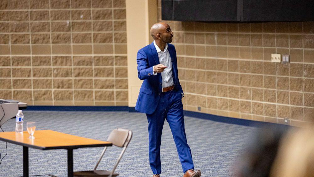 Man giving presentation at the front of a lecture hall