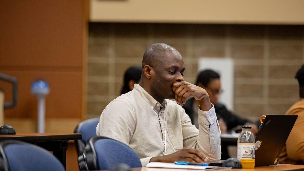 man sitting in lecture hall