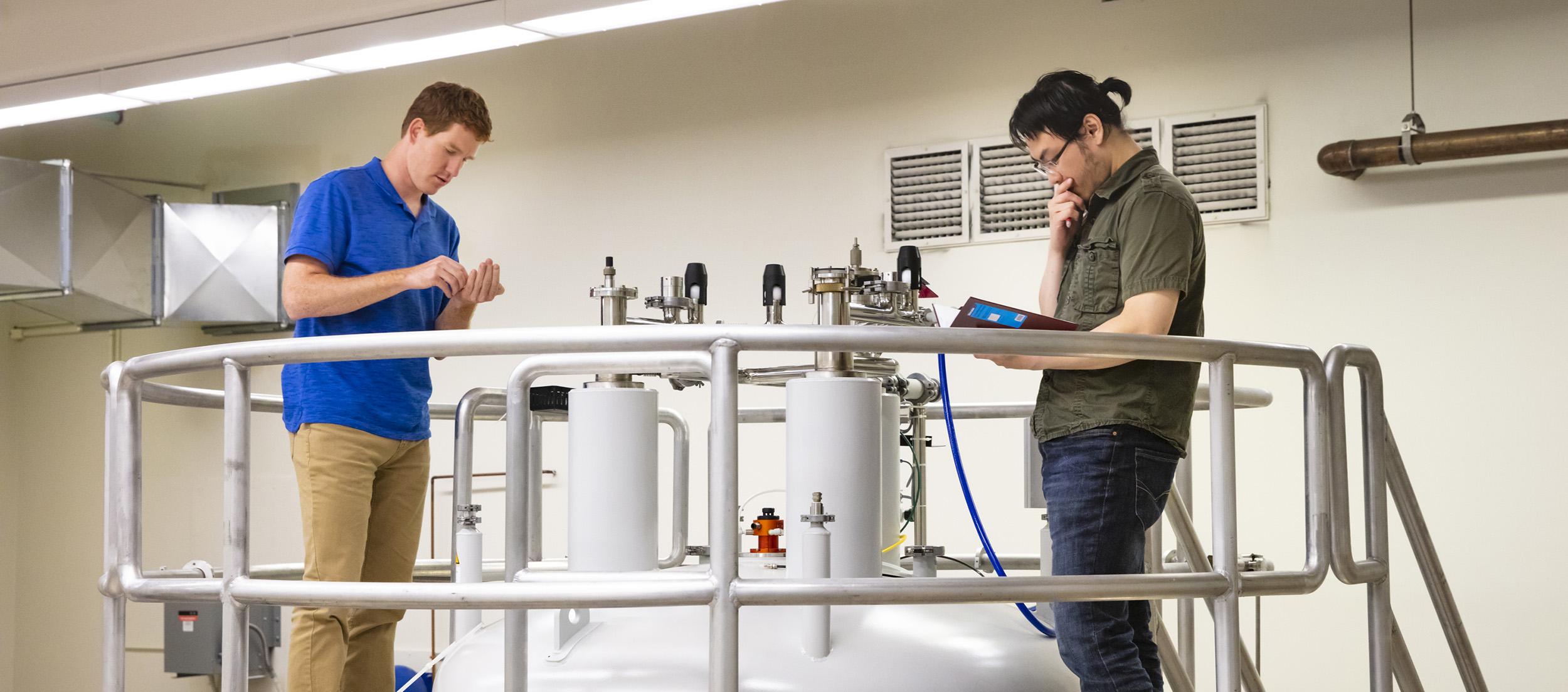 Two biophysics graduate students work together in U of G's NMR facility