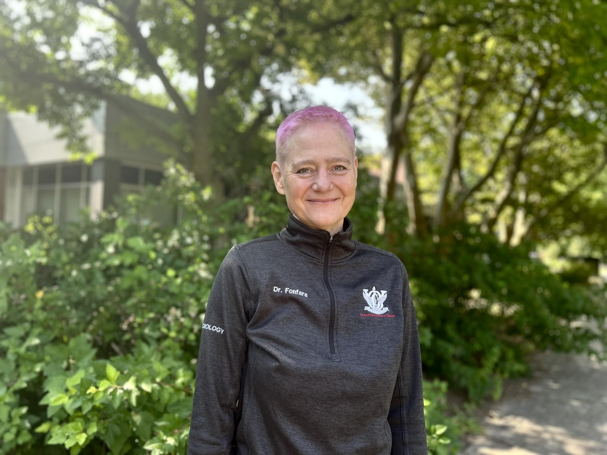Dr. Sonja Fonfara stands in front of trees