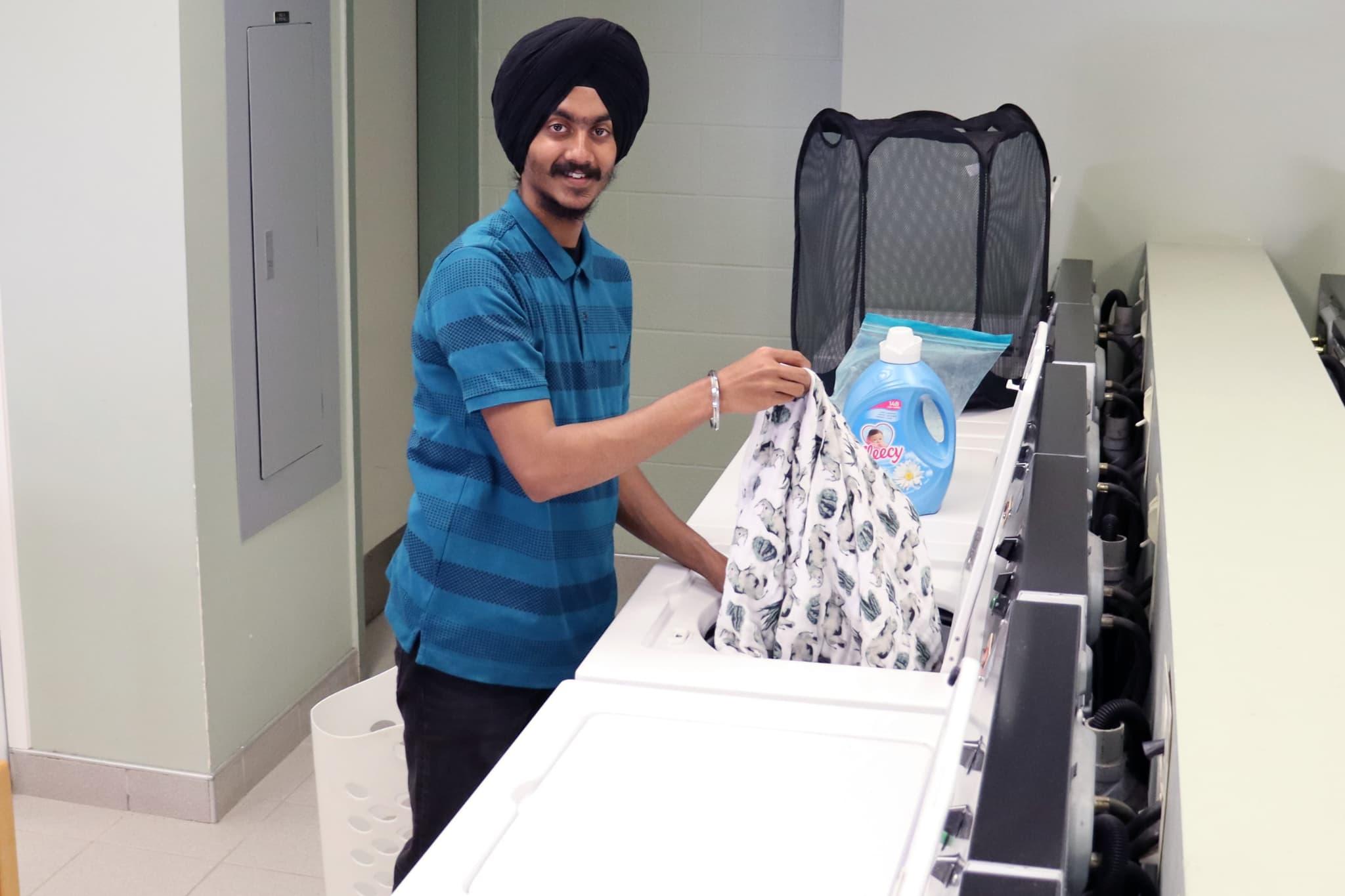 Student doing laundry in Residence