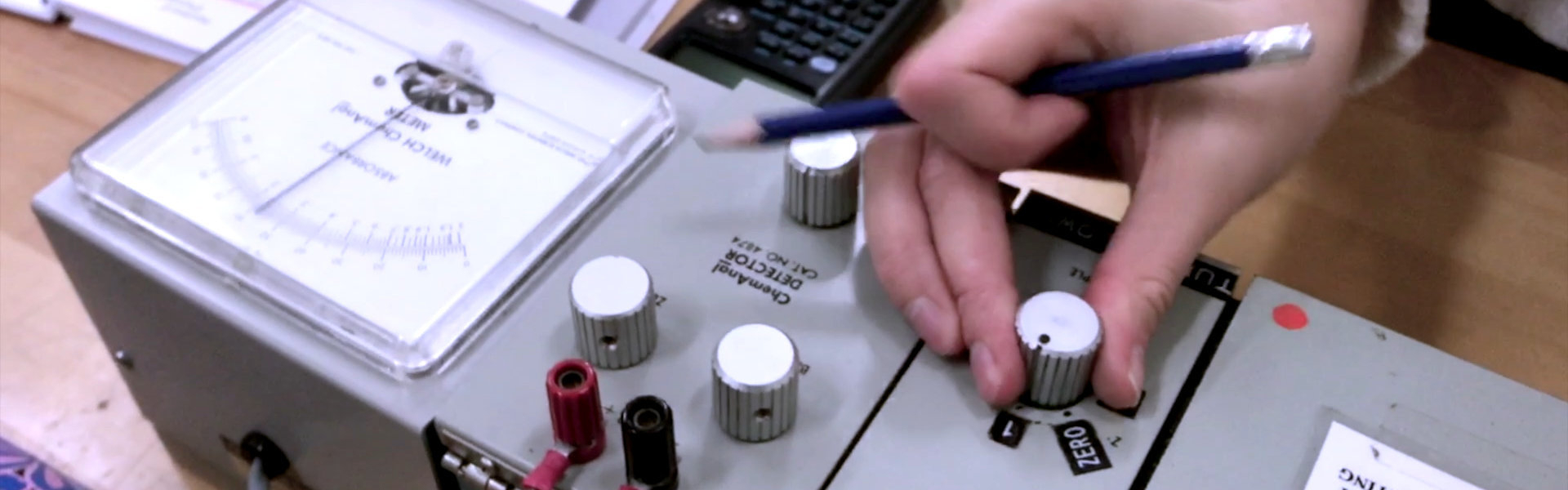 up close of a hand turning a dial on a piece of equipment