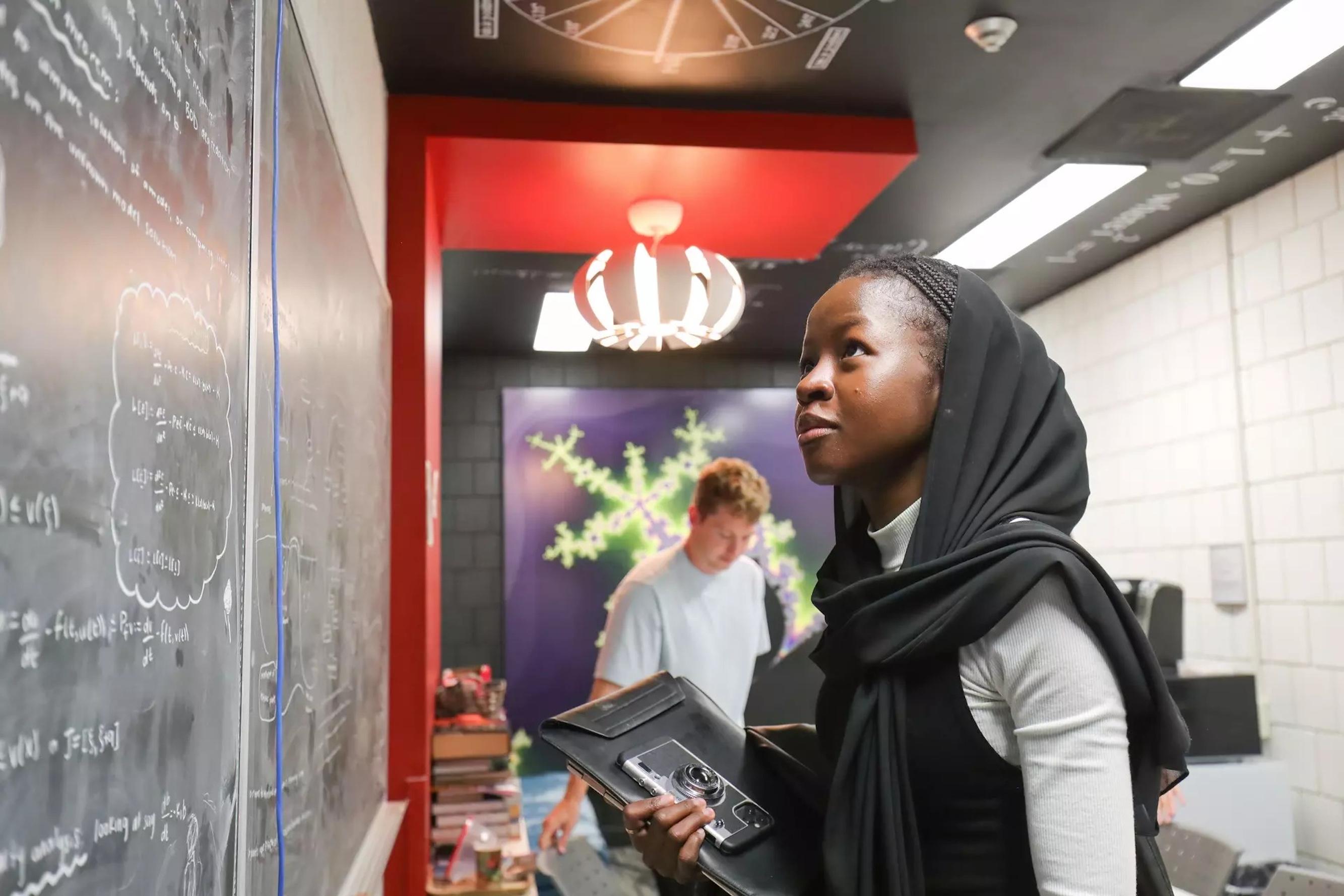 Student staring at chalkboard in wonder.