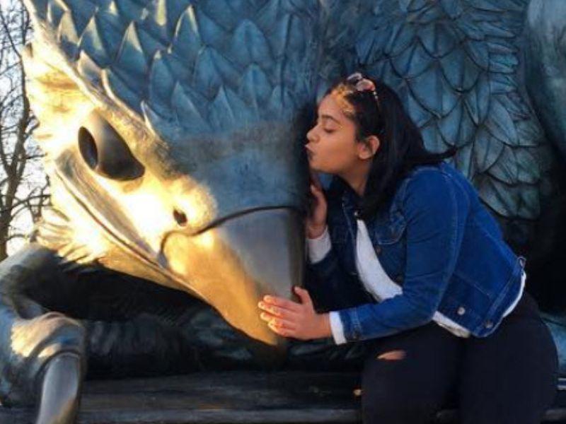 Student kissing Gryphon statue