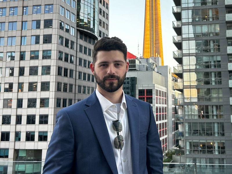 Matthew Hernandez standing in front of the CN tower.