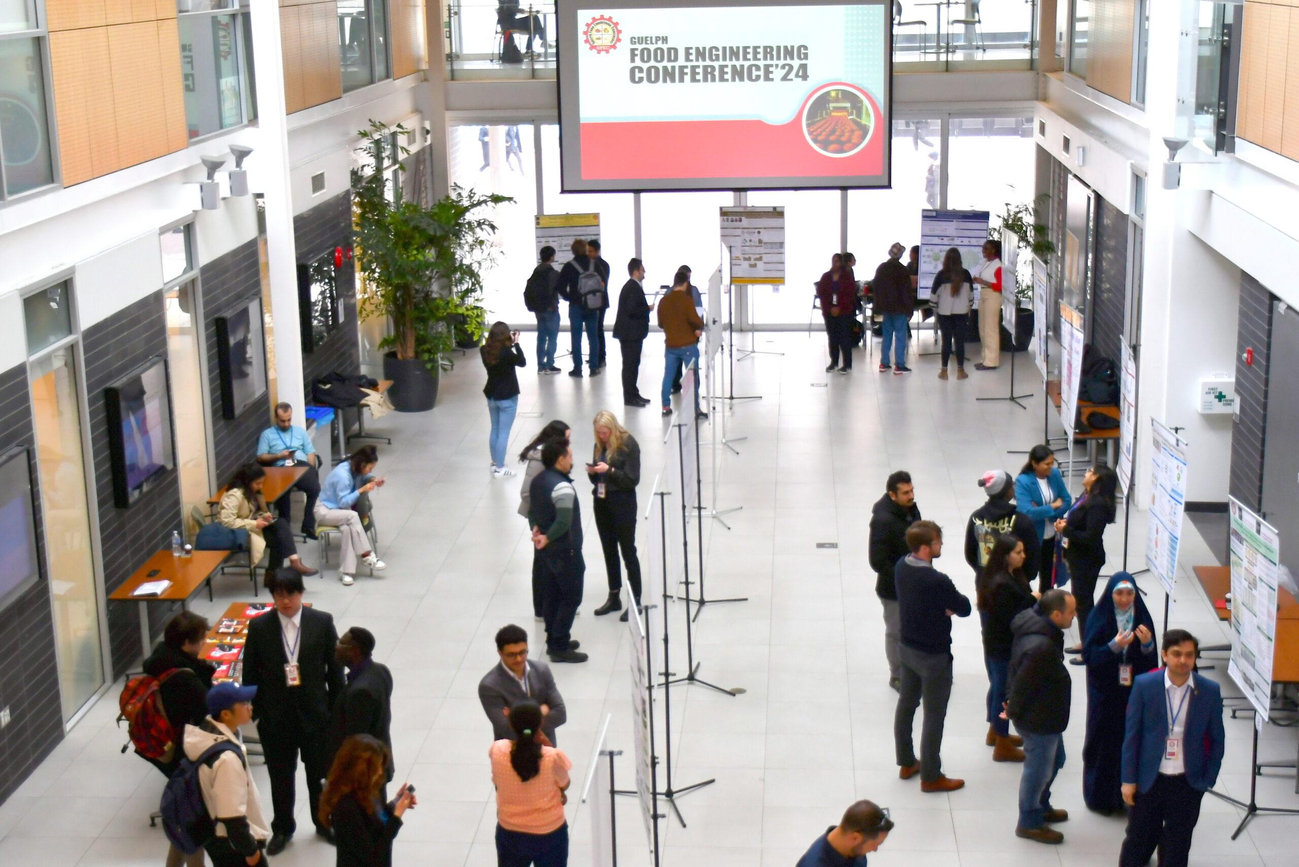 a photo from above of people attending a conference in the Atrium