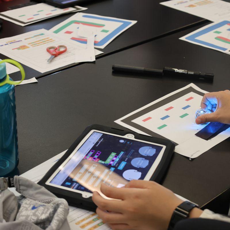 Creative Encounters camper using an Ipad to learn about ai and programming