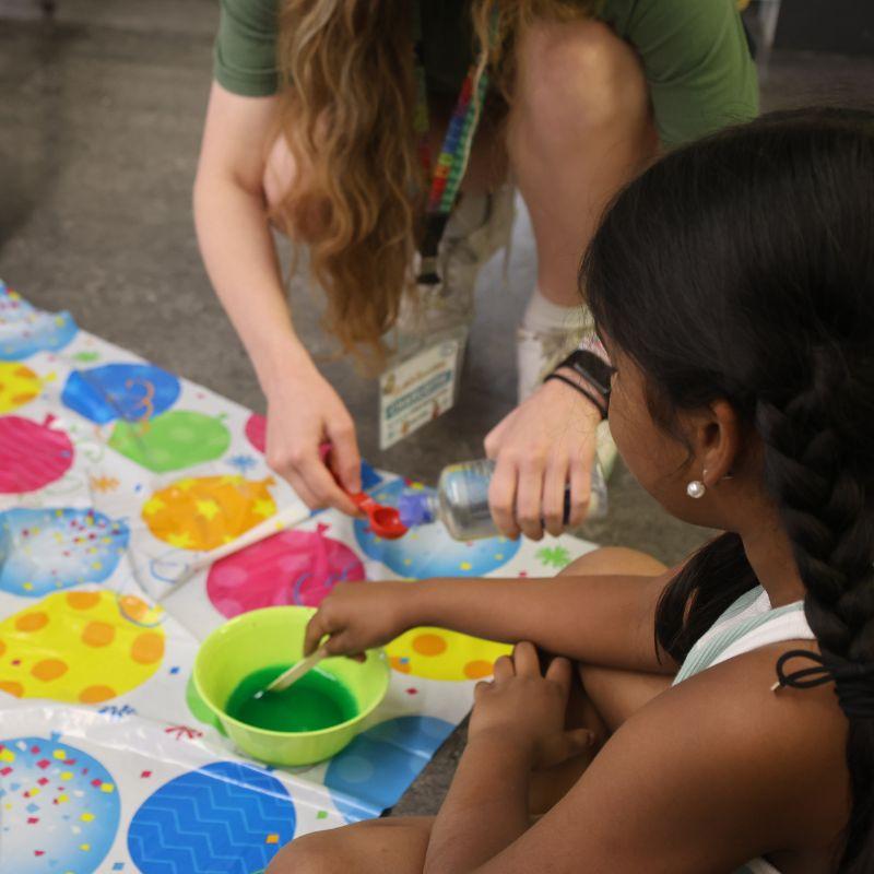 Two Creative Encounters campers exploring the physics of liquids and flow