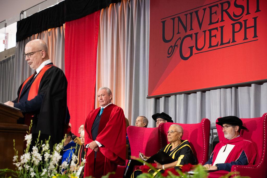 A person speaking at a podium on a stage