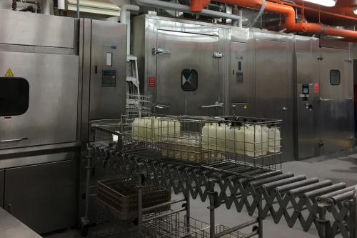 Cage washing facility containing large rectangular metal cleaning units