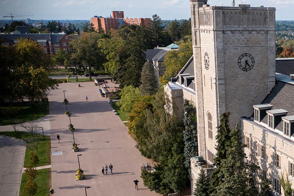 Johnston hall with people walking through the brick walkway