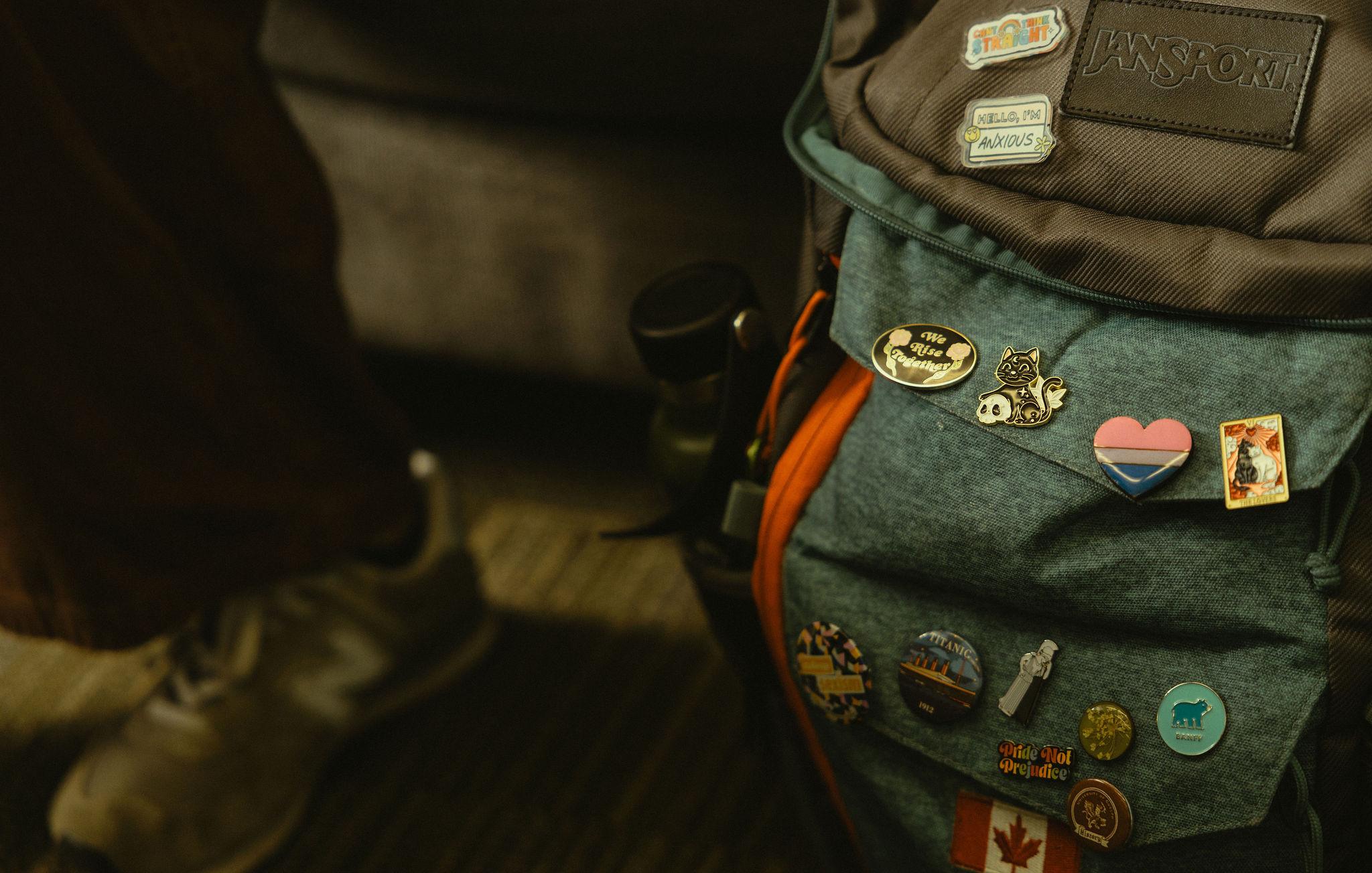 Buttons on a backpack that are activism themed.