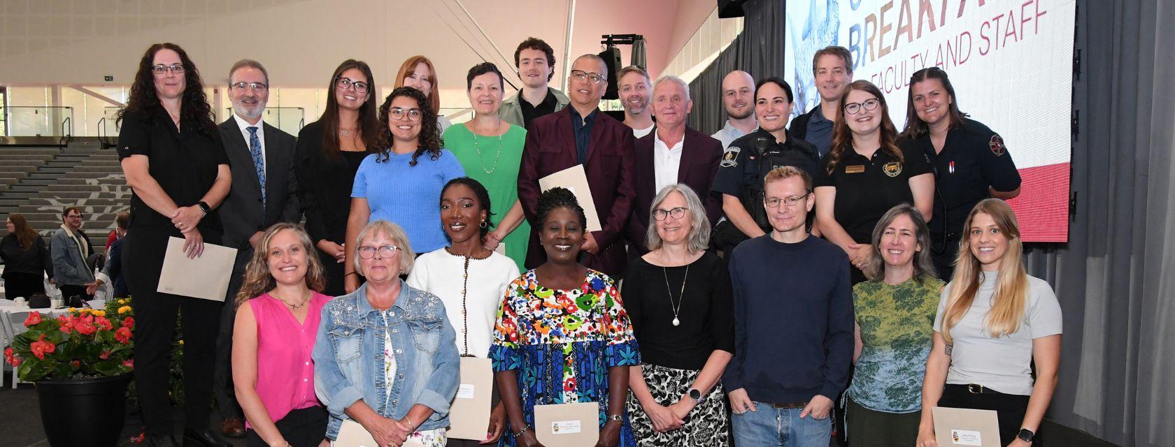 Group photo of U of G staff receiving an award at the community breakfast. 