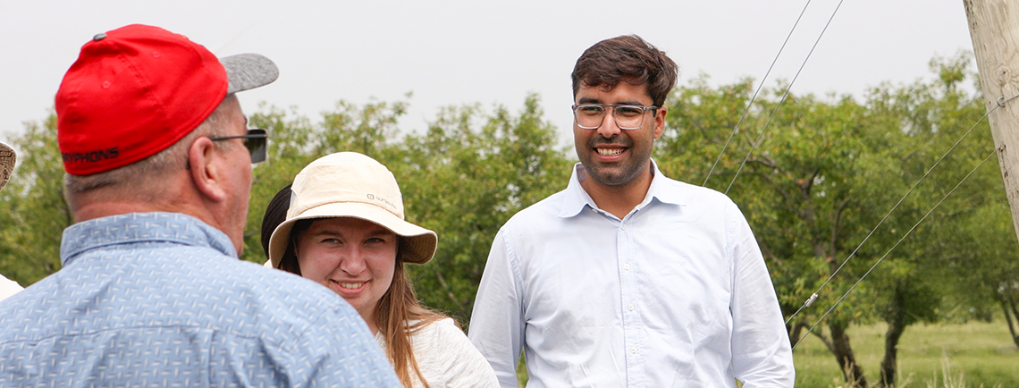students in the sustainable ag program outside talking to faculty