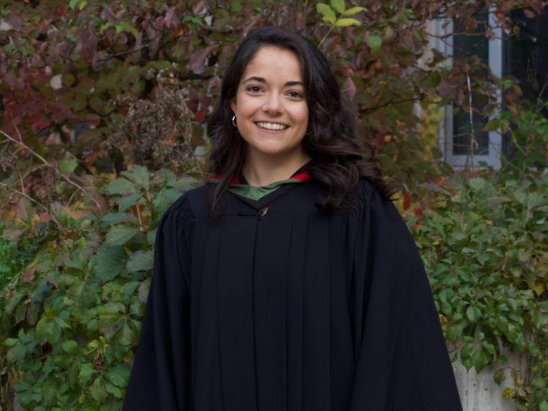 U of G Grad Tiana Bressan posing outside in her grad gown at graduation