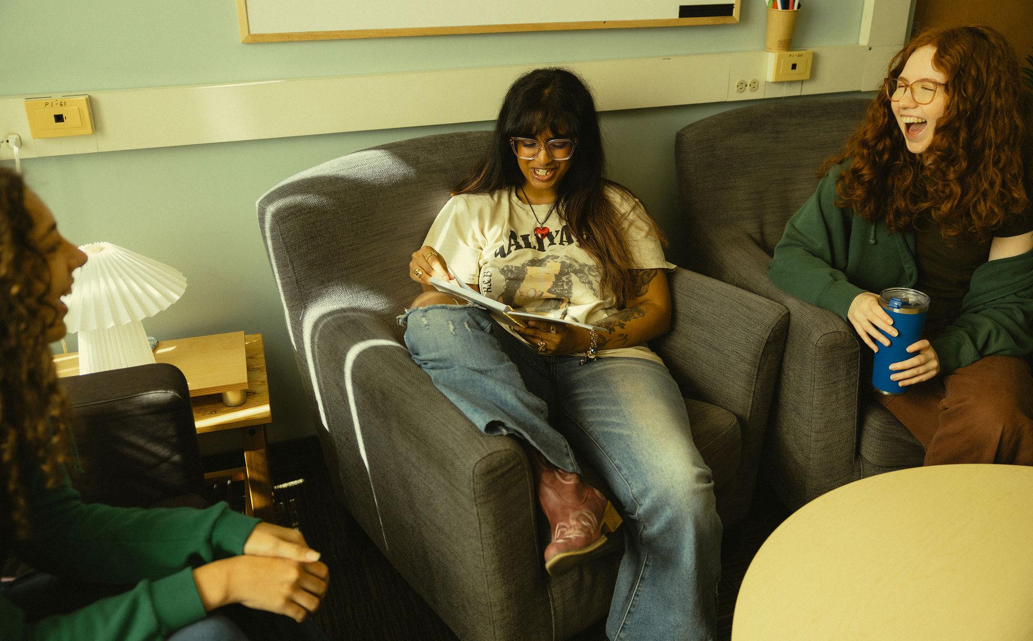 Students sitting in student lounge together, studying