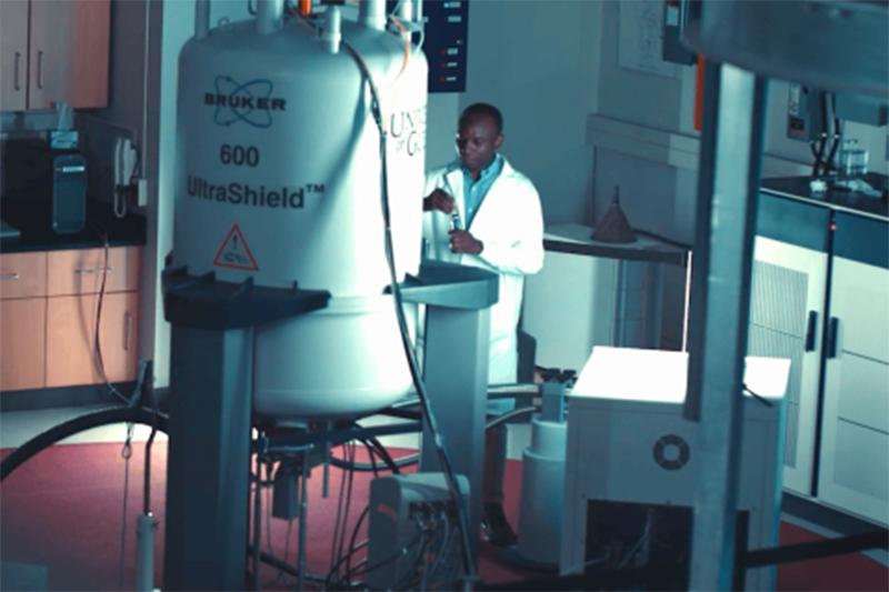 A scientist is working in a lab with a large tank