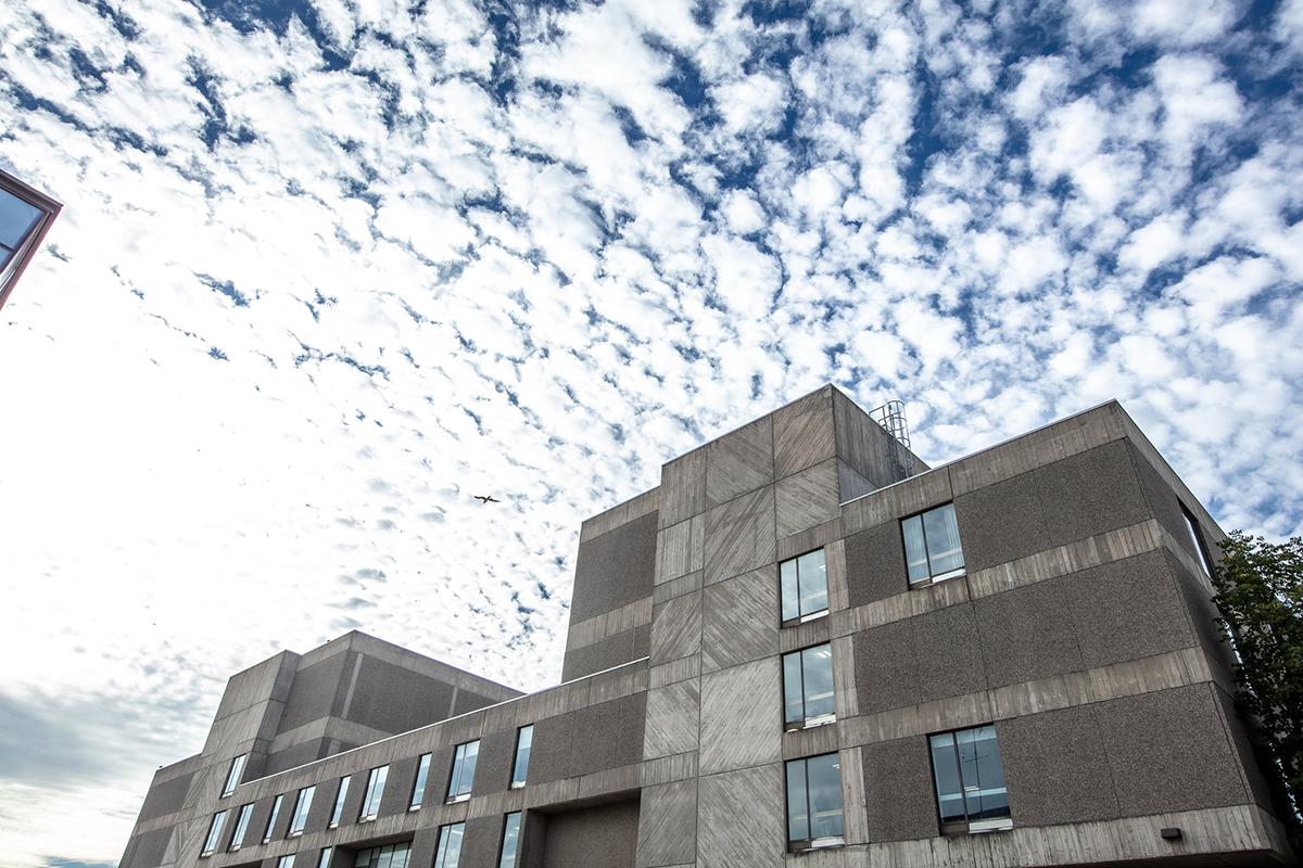 Building with white clouds above it