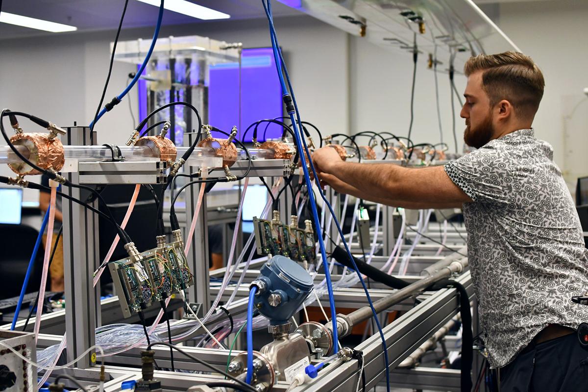 Man working with cables on machine