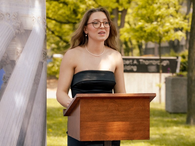JLS grad Michelle Wilk speaks at the unveiling of the commemorative bench dedicated to the JLS class of 2025.
