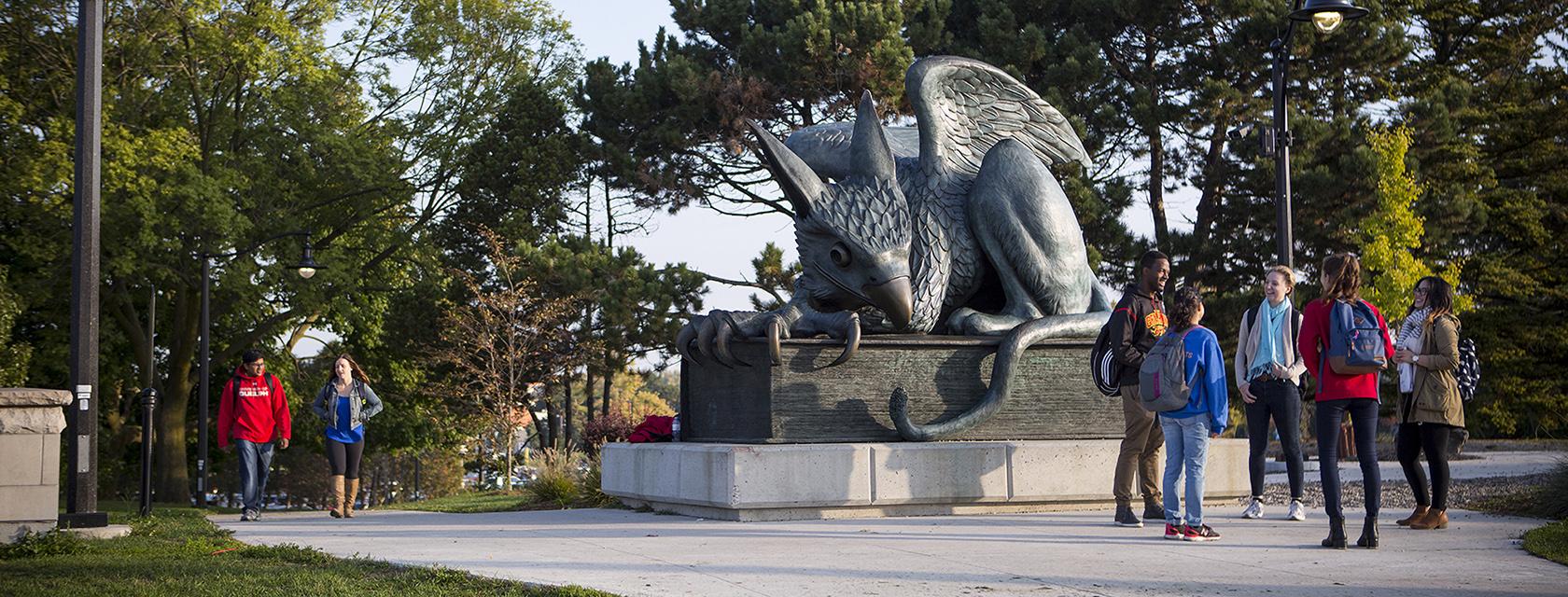 Group of students in front of the Gryphon statue.
