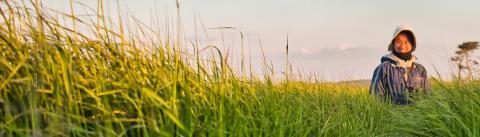 A woman in the field smiling