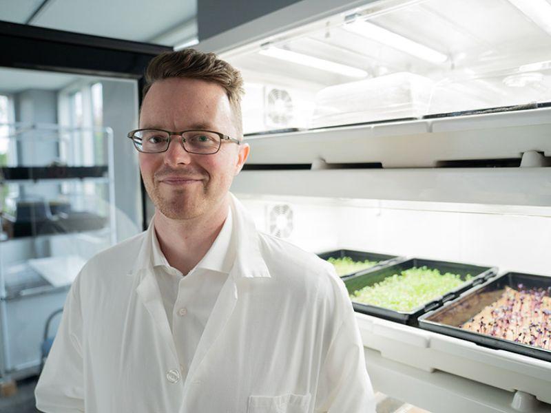 Jared Stoochnoff poses in front in the The University of Guelph’s Controlled Environment Systems Research Facility