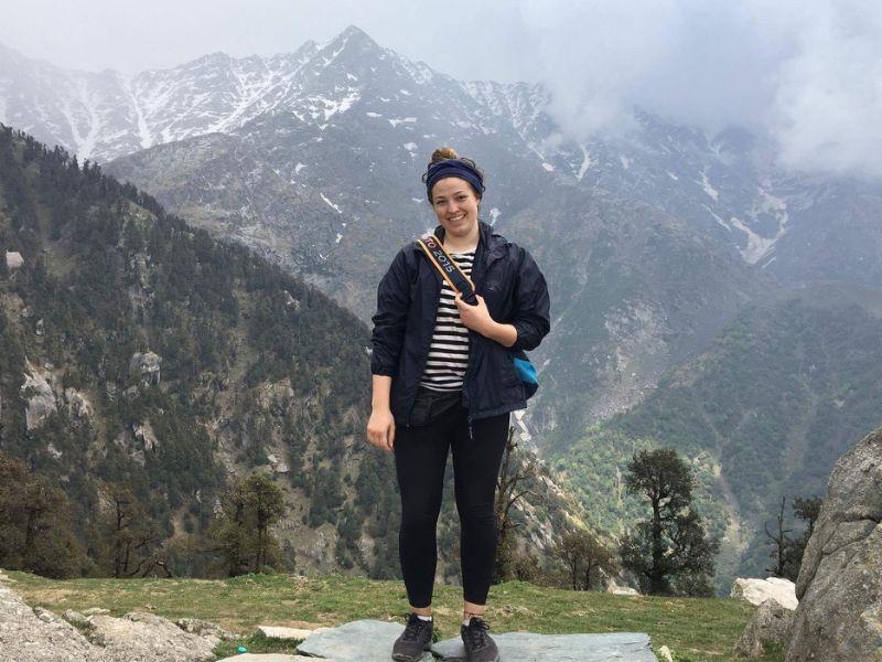 Guelph Grad Johannah Brockie poses in front of a mountain range in Tibet