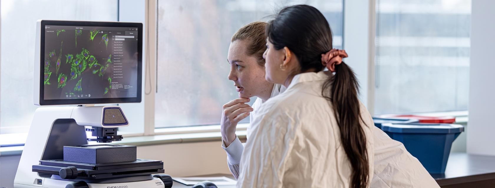 Student and instructor in front of computer