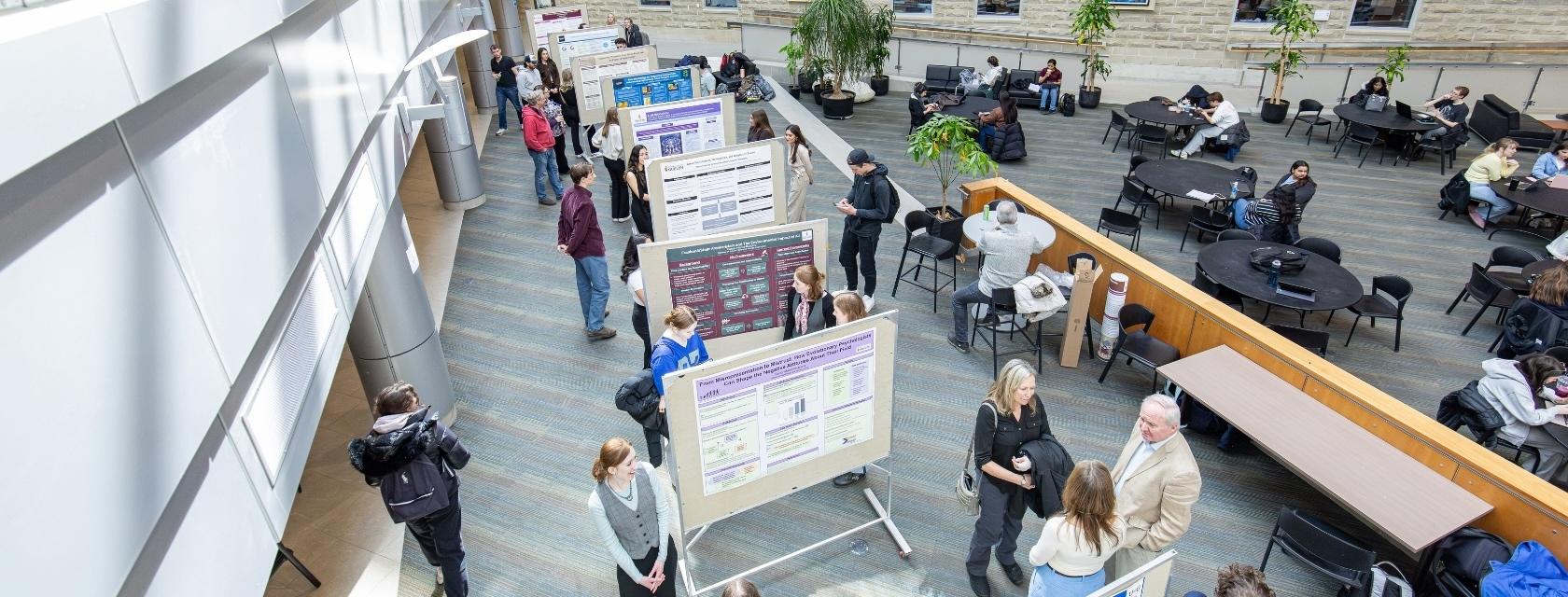 Researchers presenting posters in the Waasamowin atrium