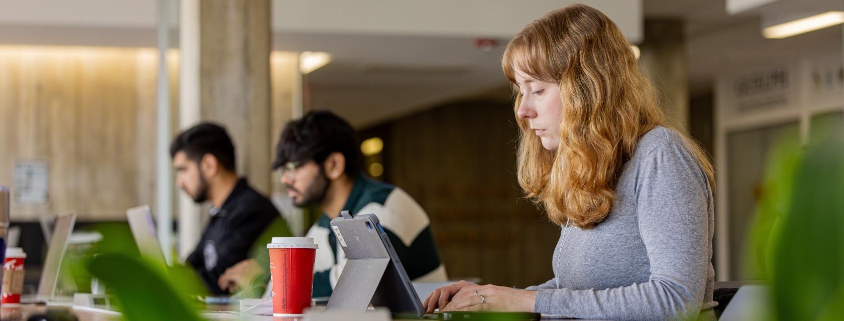 Student typing on a laptop