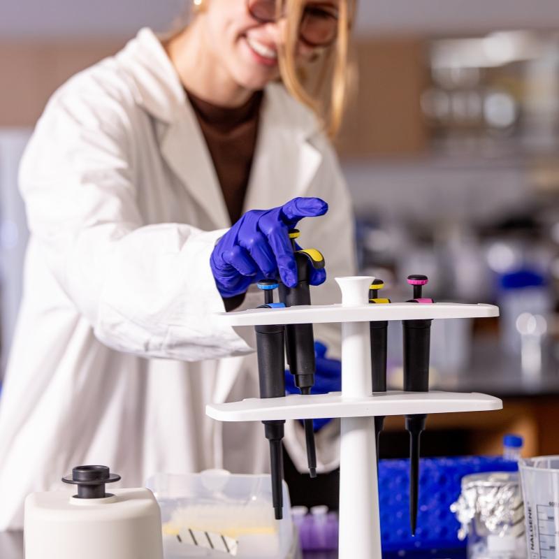 MAMHS student grabbing a pipette in the lab