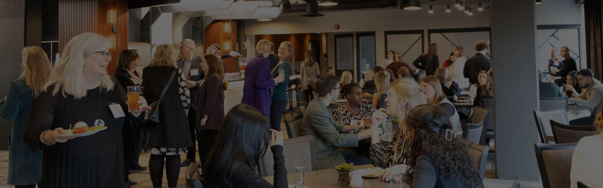People mingle with at a networking and awards event held in the University Club