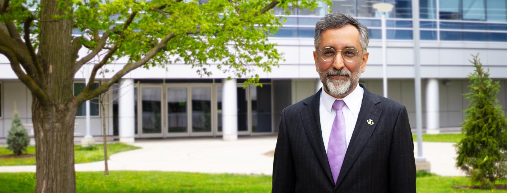 Mazyar Fallah smiling for a headshot outside the Summerlee Science Complex