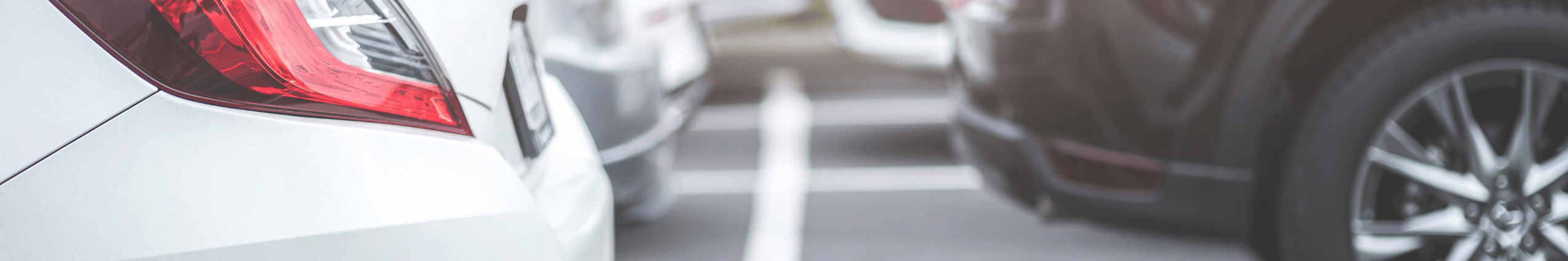 white and black cars parked in parking lot